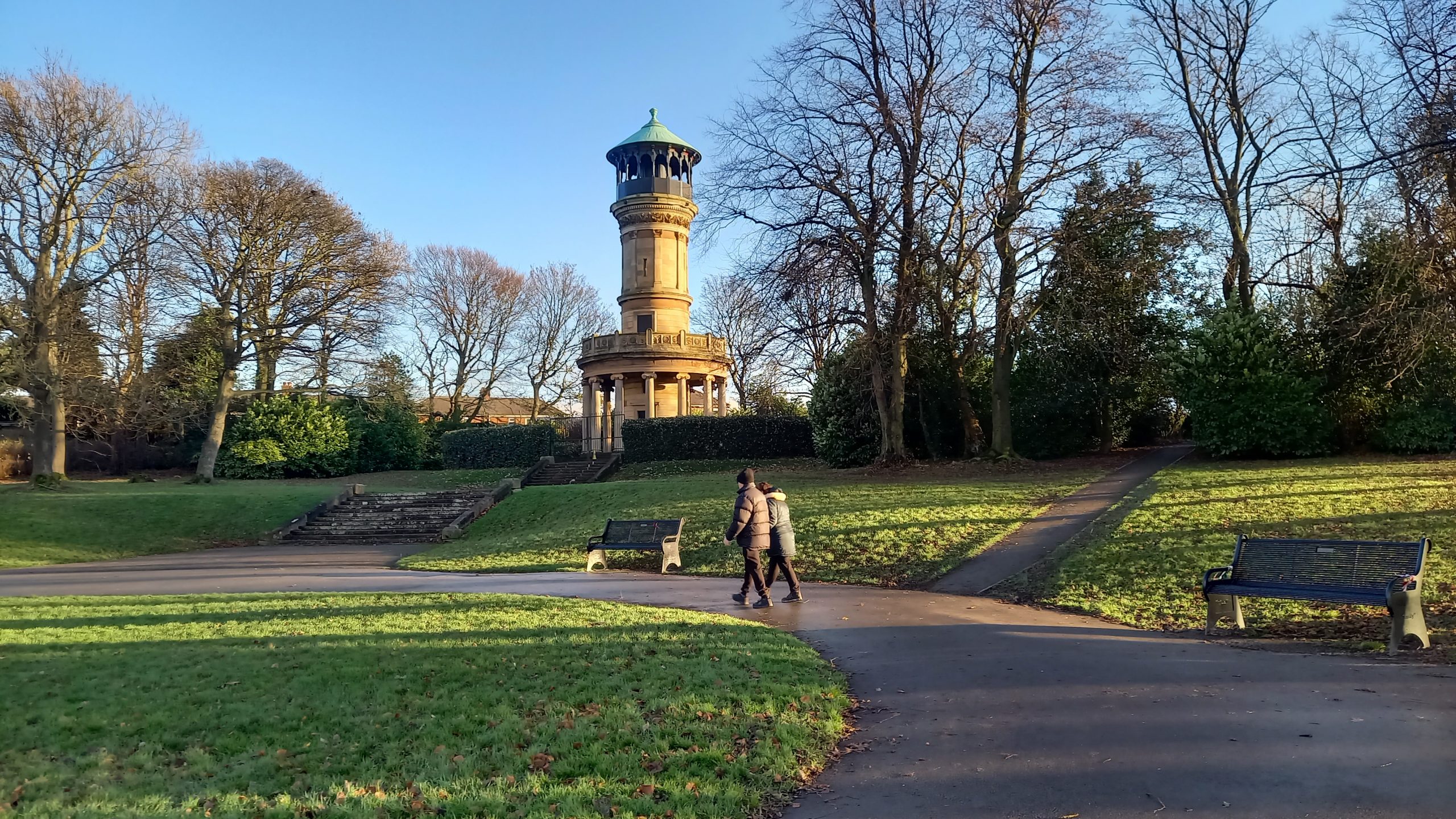 View of Locke Park tower lit by the late-Autumn sun amongst trees bare of leaves